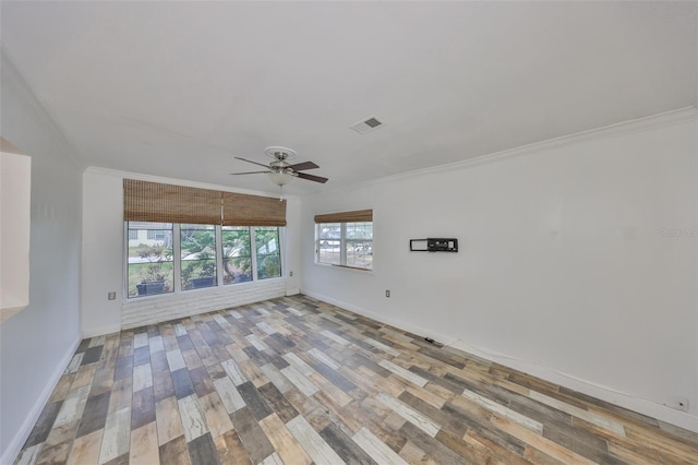 empty room with ceiling fan, light hardwood / wood-style flooring, and ornamental molding