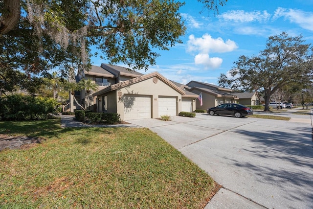 view of front of home with a garage and a front lawn