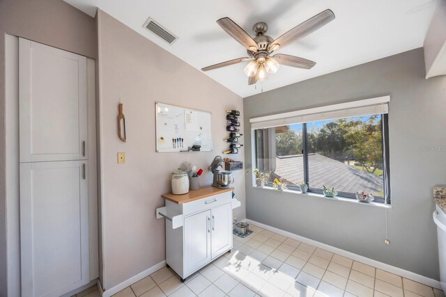 interior space featuring ceiling fan and light tile patterned floors