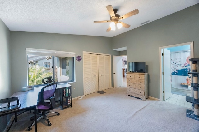 carpeted office featuring ceiling fan, a textured ceiling, and lofted ceiling