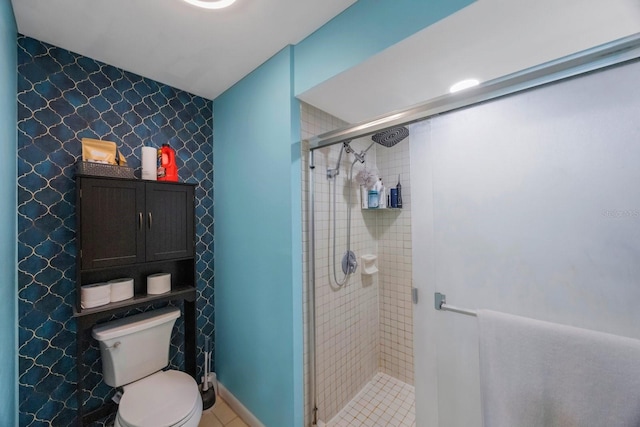 bathroom with toilet, tile patterned floors, and an enclosed shower