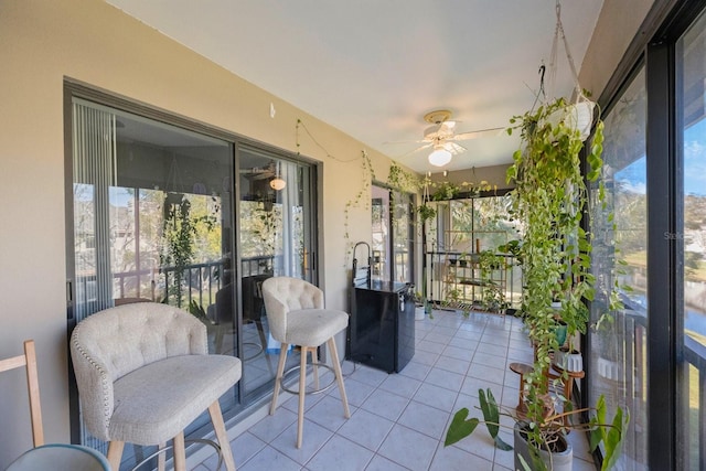 sunroom / solarium featuring ceiling fan