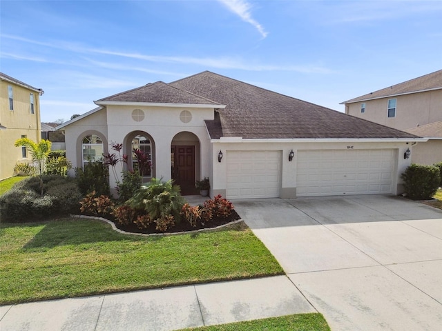 view of front of house with a garage and a front yard