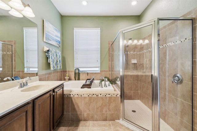 bathroom with vanity, plenty of natural light, tile patterned floors, and plus walk in shower