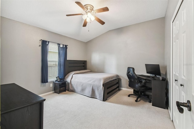 bedroom featuring lofted ceiling, light carpet, ceiling fan, and a closet