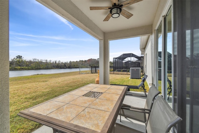 view of patio featuring a water view, ceiling fan, and cooling unit