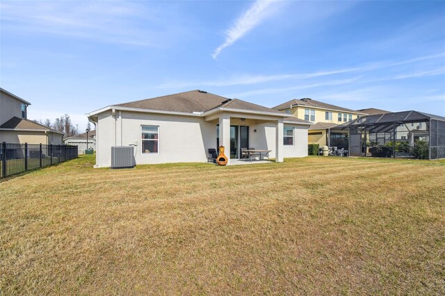 back of property featuring central AC, a lanai, and a lawn