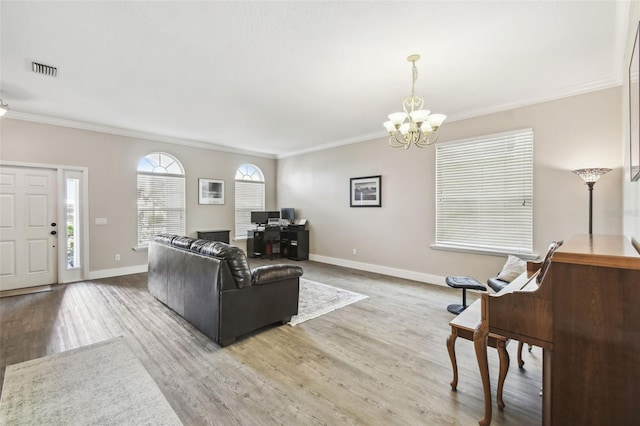 living room featuring crown molding, hardwood / wood-style floors, and an inviting chandelier