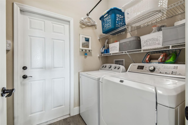 laundry room featuring hardwood / wood-style flooring and separate washer and dryer