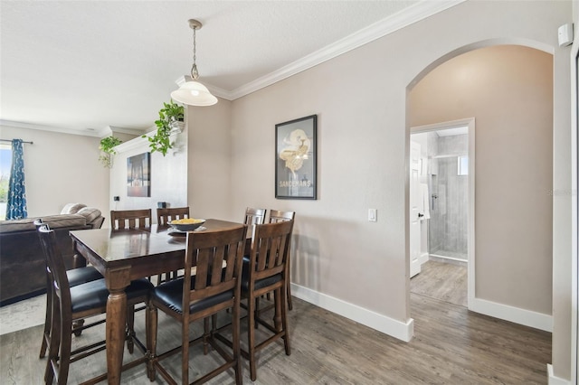 dining room featuring dark wood-type flooring and ornamental molding