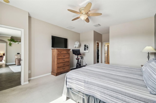 bedroom featuring light carpet and ceiling fan