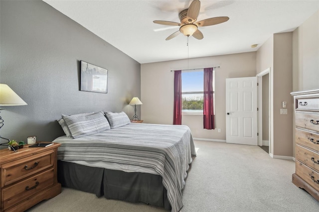 bedroom featuring light colored carpet and ceiling fan