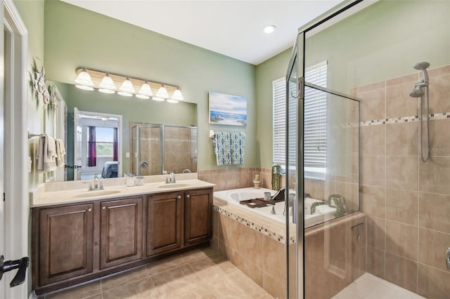 bathroom featuring tile patterned floors, independent shower and bath, and vanity