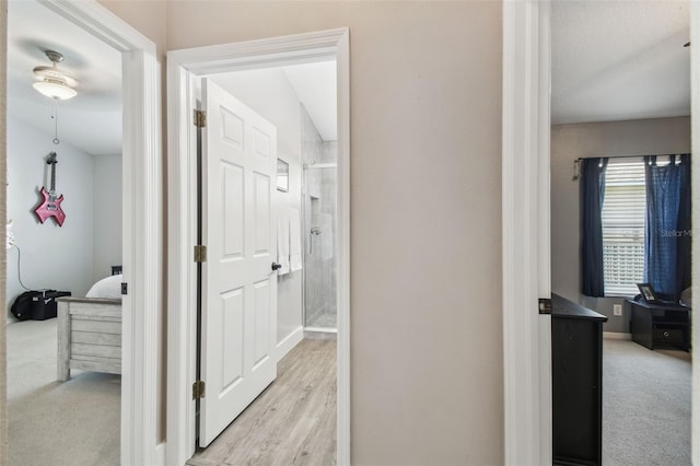 hallway featuring light carpet