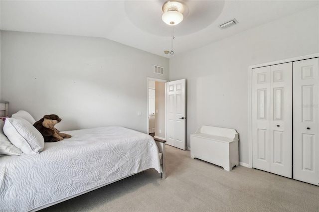 bedroom with ceiling fan, a closet, lofted ceiling, and light carpet