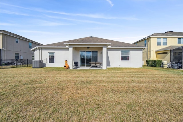 rear view of house featuring central AC, a patio, and a lawn