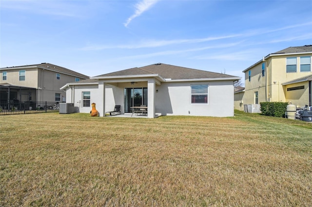 back of house with a yard, central AC unit, and a patio