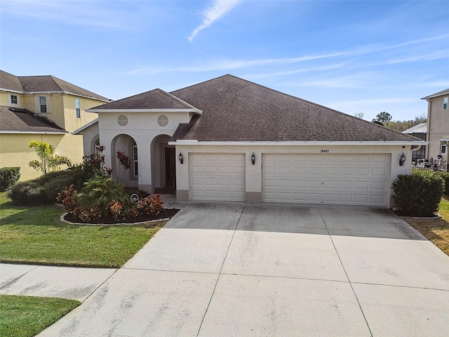 view of front facade featuring a garage and a front yard