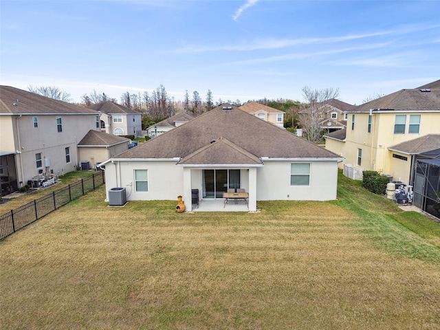 rear view of house with a lawn, a patio, and central air condition unit