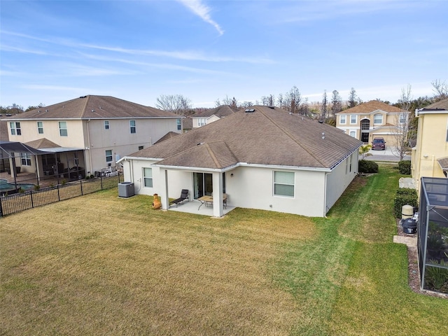 rear view of house featuring central AC, a patio area, and a lawn