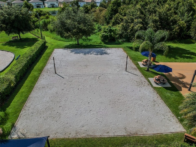 view of property's community with a yard and volleyball court