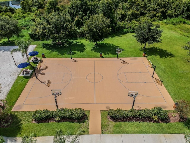 view of sport court featuring a lawn