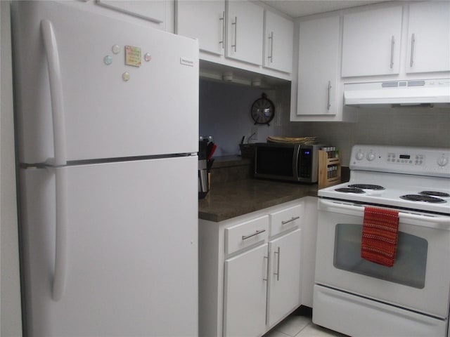 kitchen with white appliances, white cabinets, and light tile patterned flooring