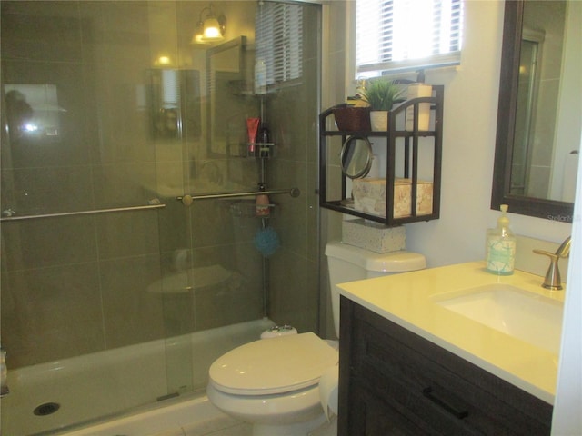 bathroom with toilet, walk in shower, and vanity