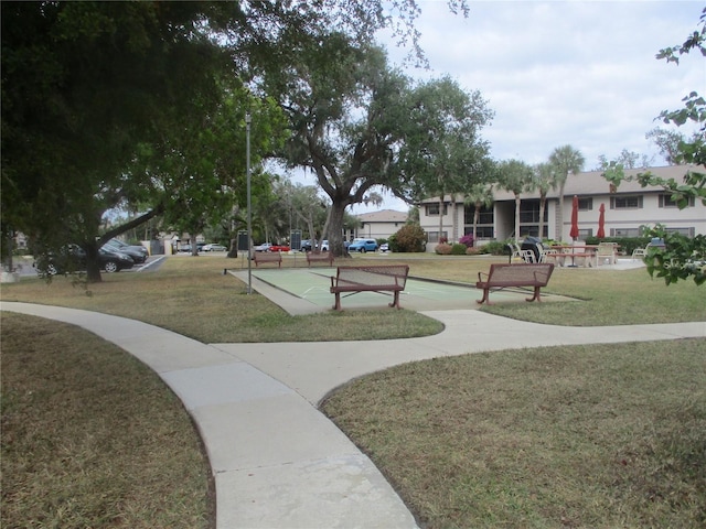 view of property's community with a lawn