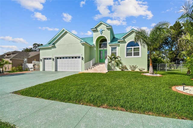 view of front of property featuring a front lawn and a garage