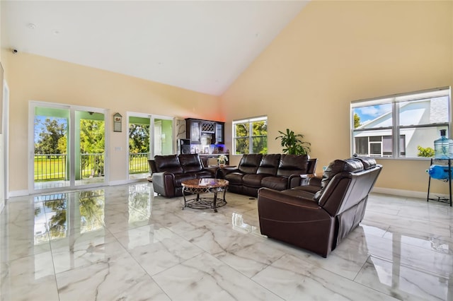 living room with high vaulted ceiling