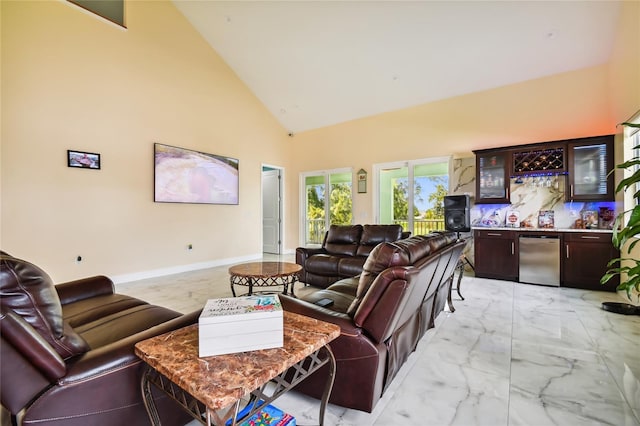 living room featuring high vaulted ceiling and indoor bar