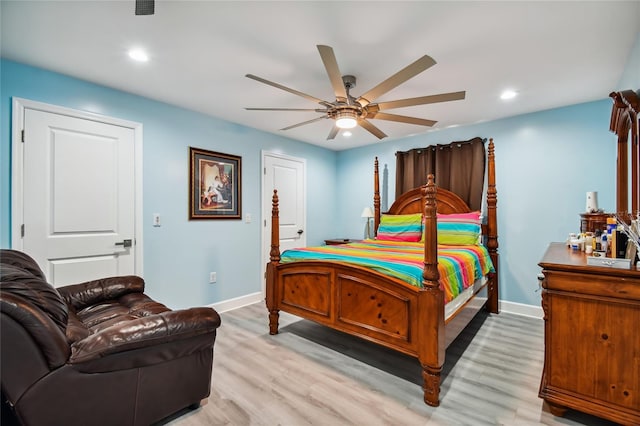 bedroom with ceiling fan and light hardwood / wood-style floors