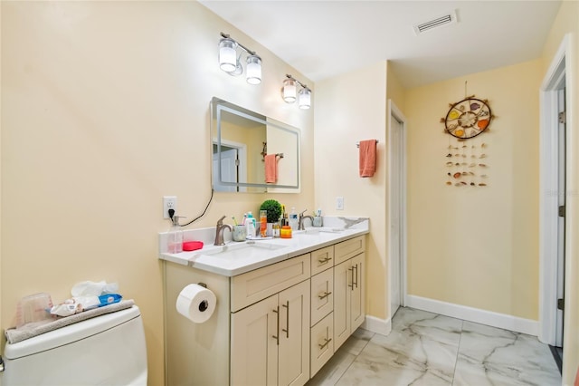 bathroom featuring toilet and vanity