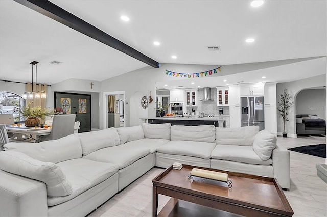 living room with light hardwood / wood-style floors and lofted ceiling with beams