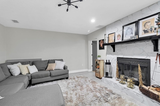 living room featuring light wood-type flooring and a fireplace