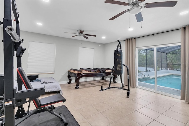 workout area featuring ceiling fan and light tile patterned flooring