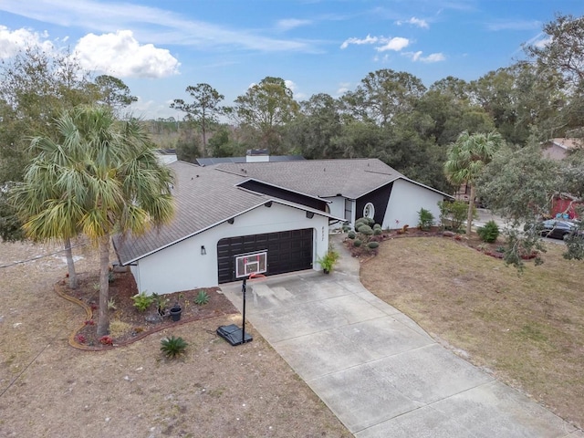 ranch-style home with a garage and a front lawn