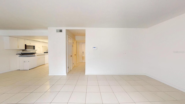 spare room featuring light tile patterned floors