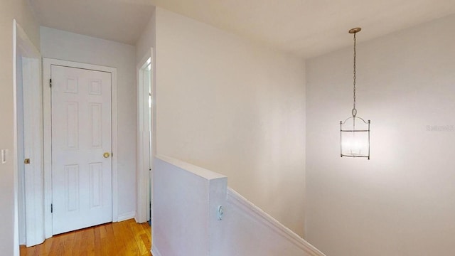 corridor with light hardwood / wood-style flooring