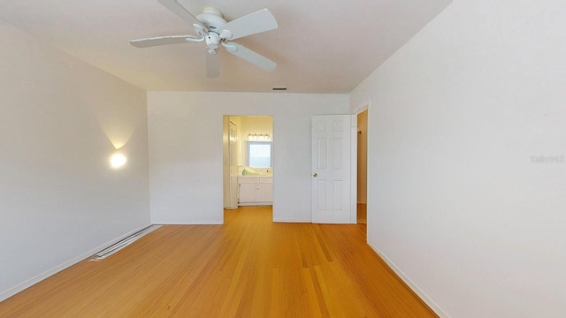 empty room featuring light wood-type flooring and ceiling fan