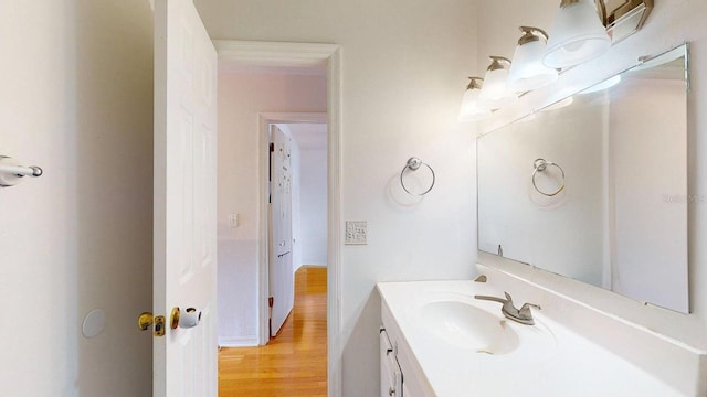 bathroom with vanity and hardwood / wood-style flooring