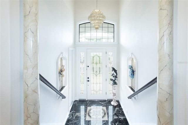 foyer entrance with a towering ceiling