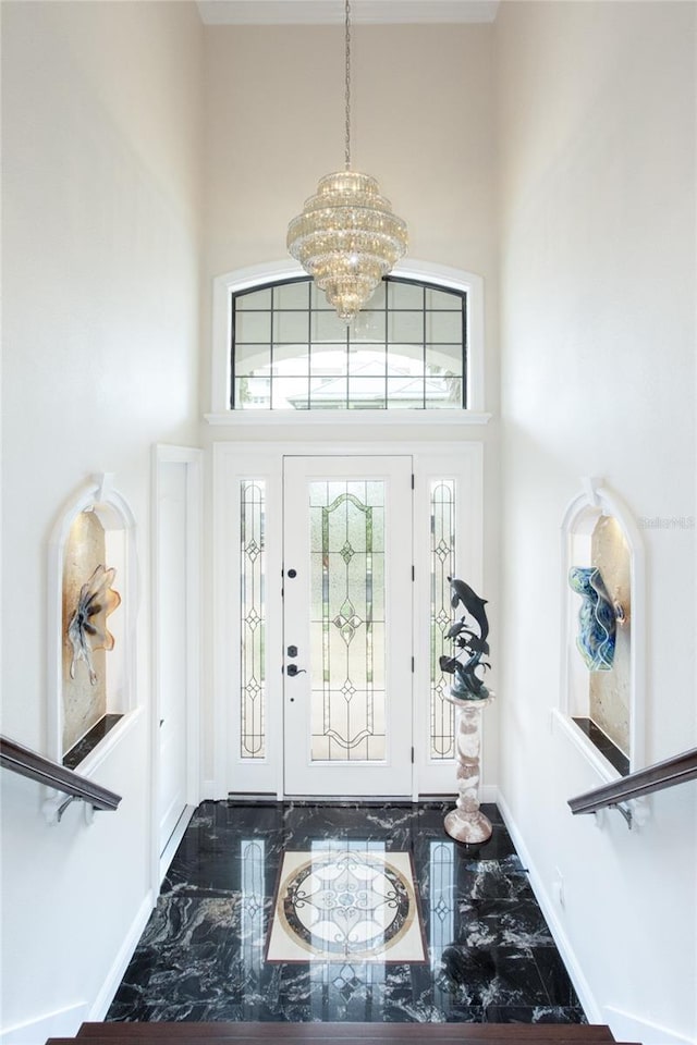 foyer featuring a high ceiling and a chandelier