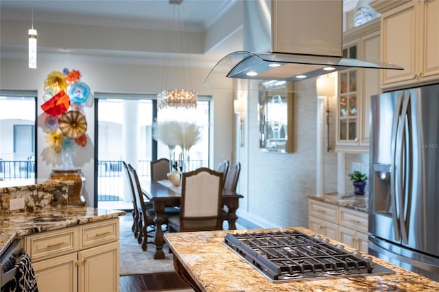 kitchen featuring dark wood-type flooring, island range hood, stainless steel appliances, light stone countertops, and cream cabinetry