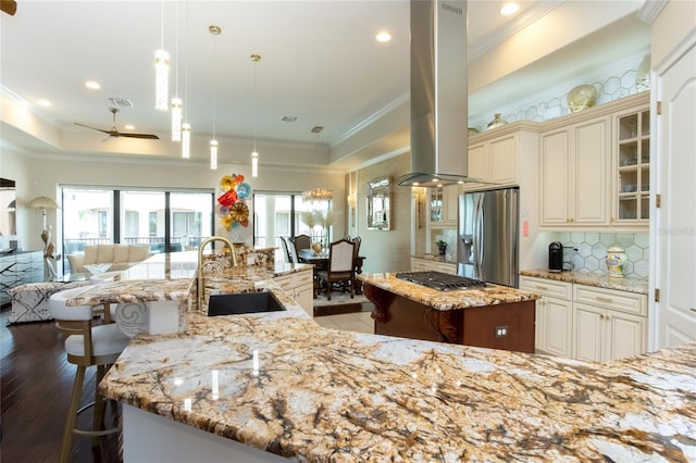 kitchen featuring sink, hanging light fixtures, island exhaust hood, stainless steel appliances, and a large island