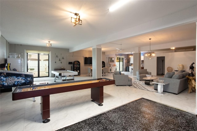 game room featuring a chandelier