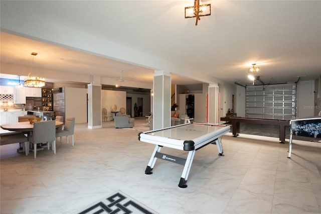 game room with an inviting chandelier