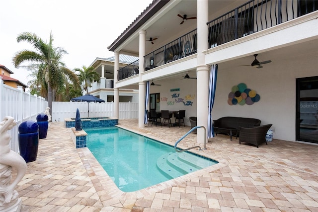 view of pool with a patio area and ceiling fan