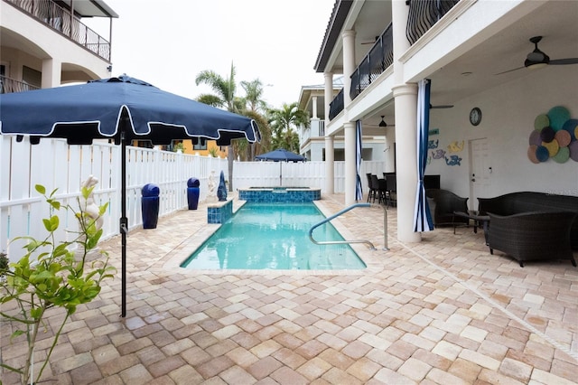 view of swimming pool featuring ceiling fan and a patio area